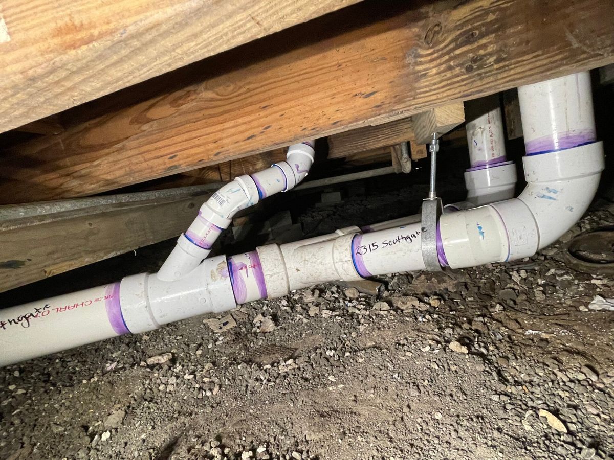 PVC drain lines repaired under a house floor